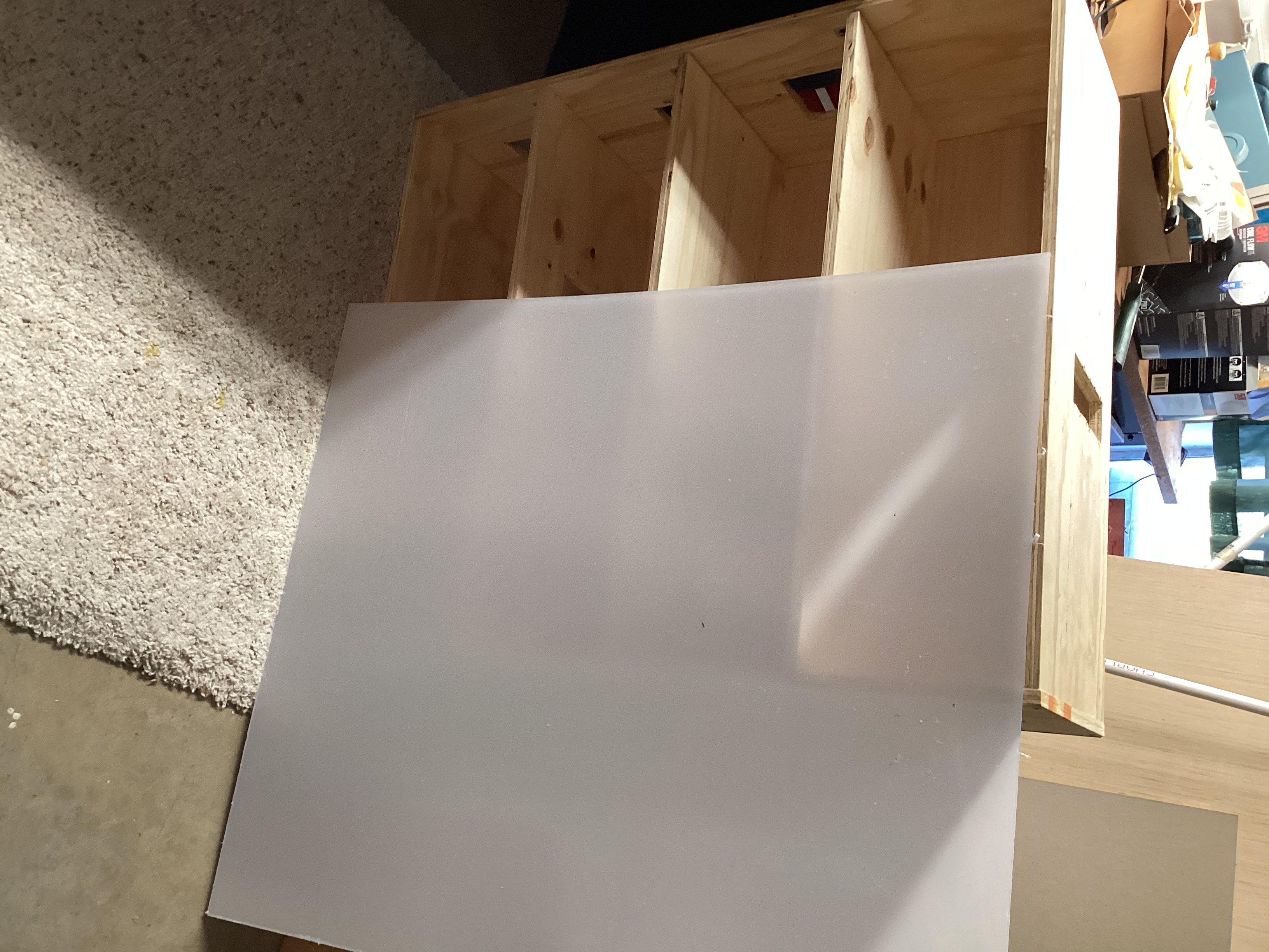 acrylic sheet with film resting against dollhouse