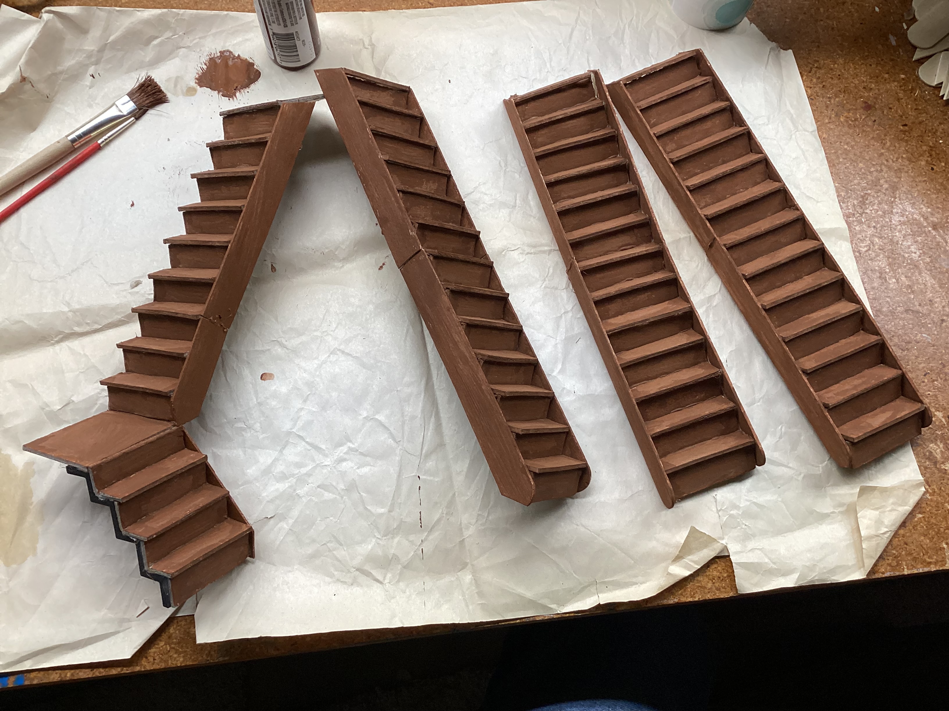 four sets of model stairs painted brown