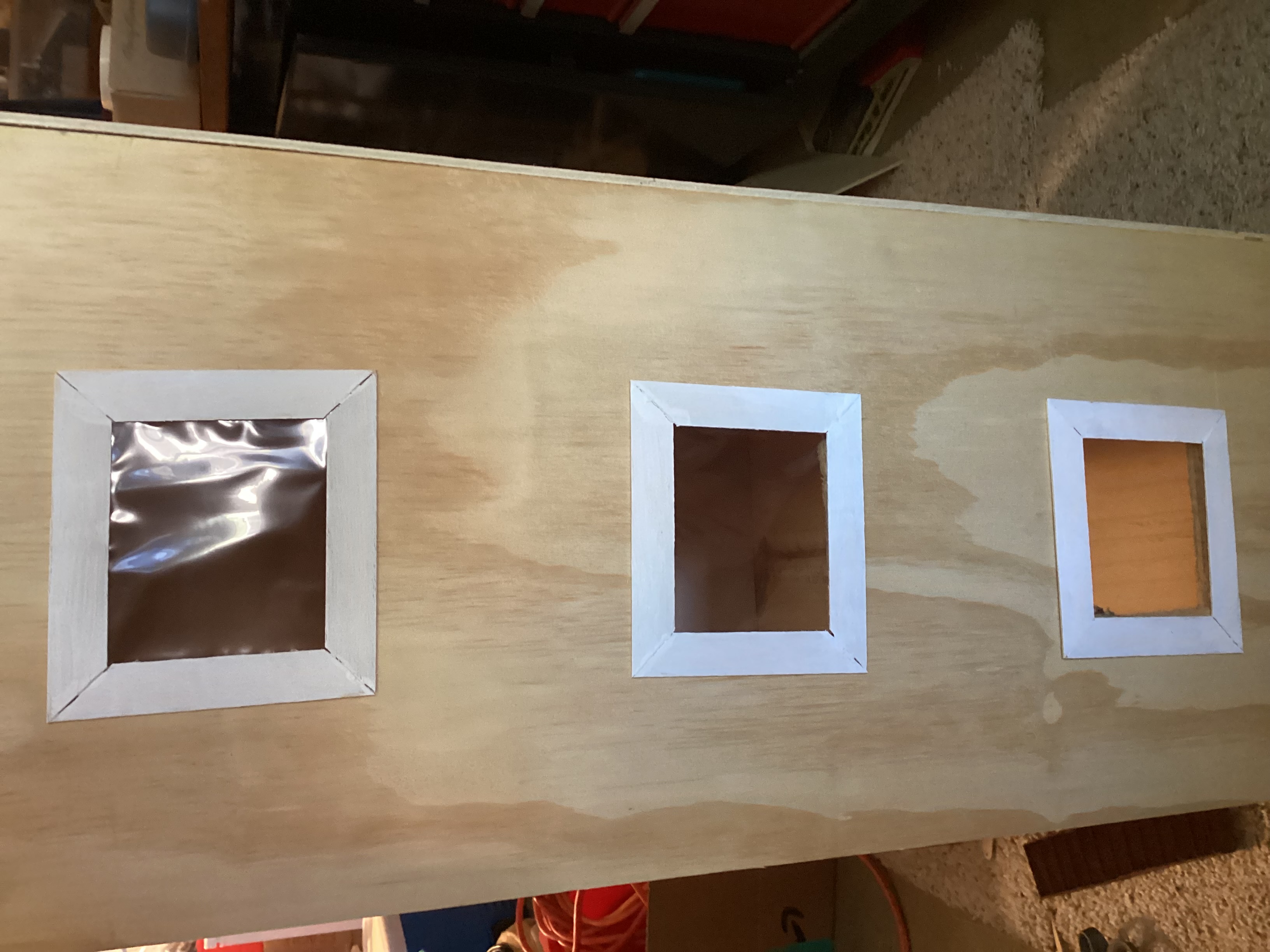 side of dollhouse with three windows